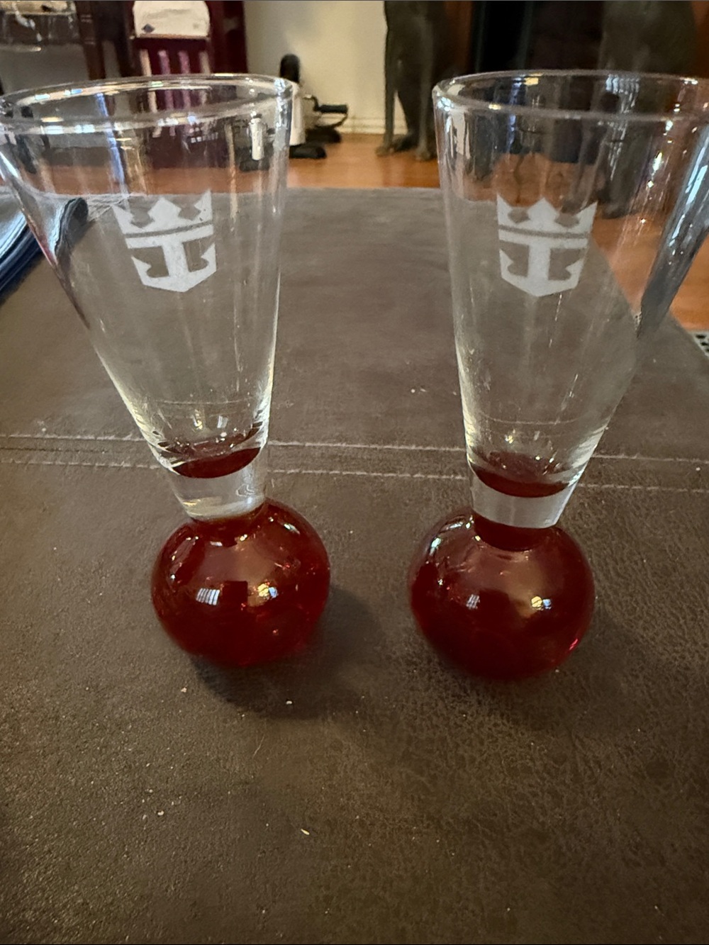 Hand-blown glass cordial/liqueur glass with red controlled bubble base
-